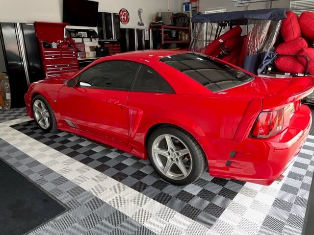 silver and grey ribbed tiles with red car