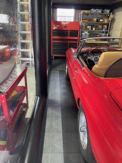 Red vehicle and gray and black tiles