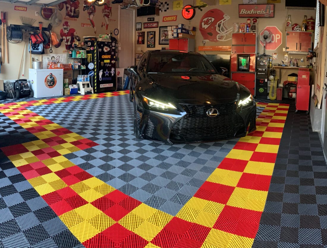 Black car on ribbed garage floor tiles